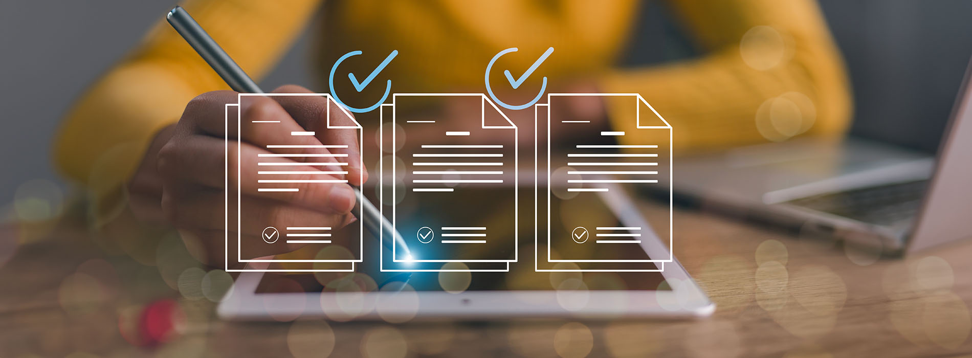 A person writing on a tablet with a digital checklist on the screen, set against a blurred background of a laptop and a notebook.